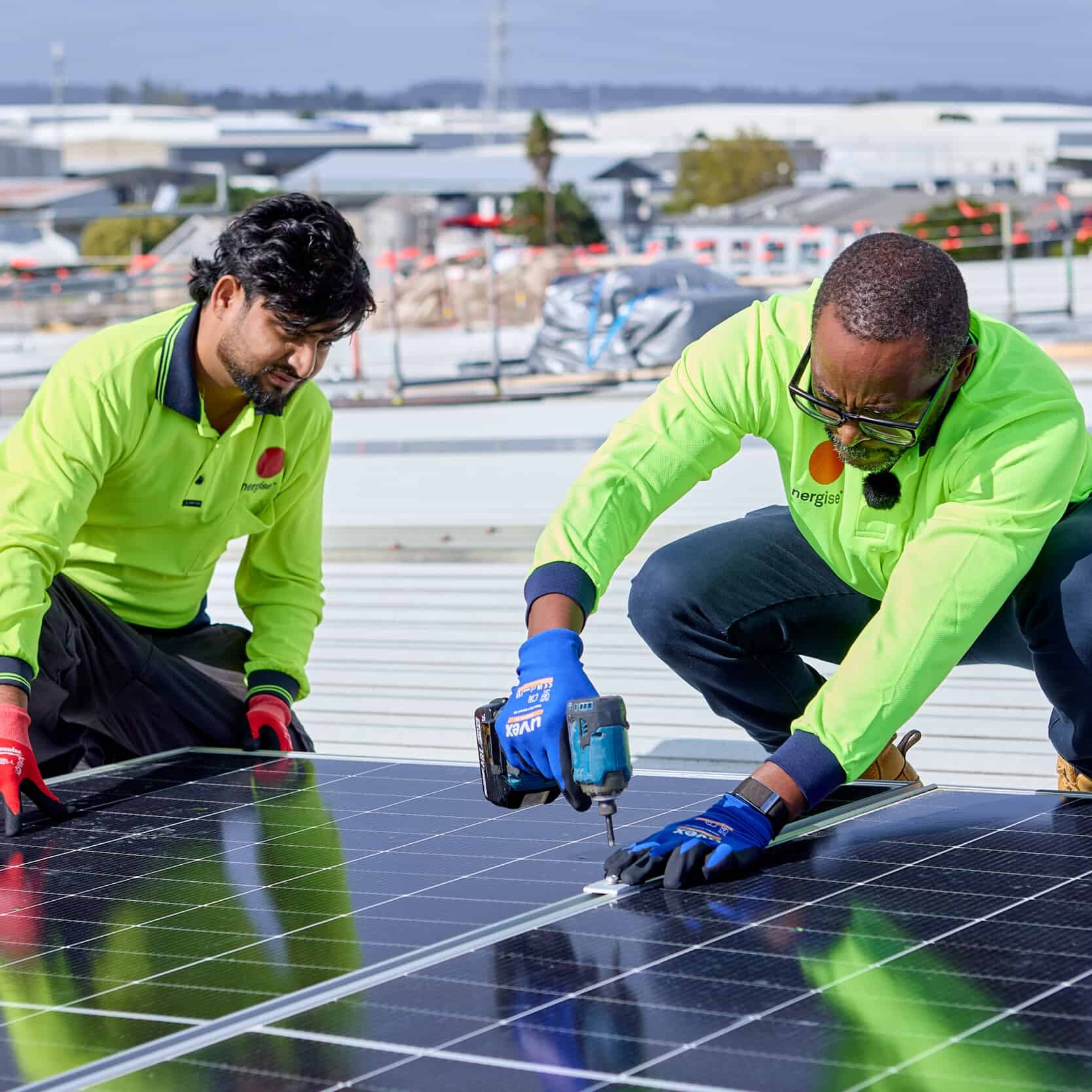 Paul Makumbe installing rooftop solar panels for renewable energy project